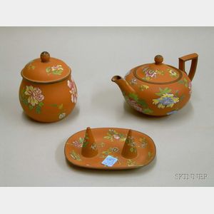 Wedgwood Enamel Floral Decorated Rosso Antico Teapot, Covered Sugar, and Snuffer Stand.
