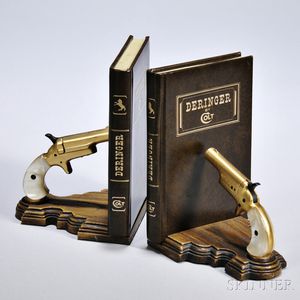 Colt Deringer Bookends, designed as leather-bound books and a pair of gold-plated pearl-handled single-shot pistols.