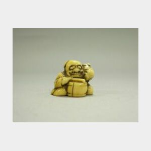 Japanese Carved Ivory Netsuke of Man in Mask Beating Drum.