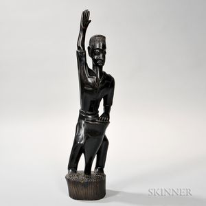 Carved Wooden Figure of a Man with a Drum. 