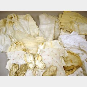 White Cotton and Linen Baby Clothes, Shoes, and Bonnets and a Group of Adults Under Clothes.