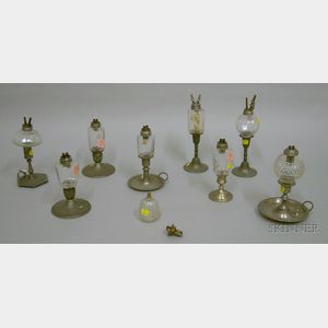 Nine Colorless Glass Peg Lamps on Pewter Candlestick Bases.