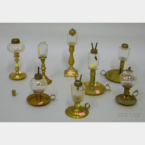 Eight Colorless Glass Peg Lamps on Brass Candlestick Bases