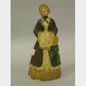 Painted Cast Iron Woman in an Ermine Trimmed Coat and Muff Doorstop