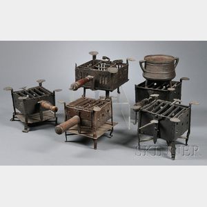 Five Wrought Iron Camp Stoves and a Footed Pot with Handles