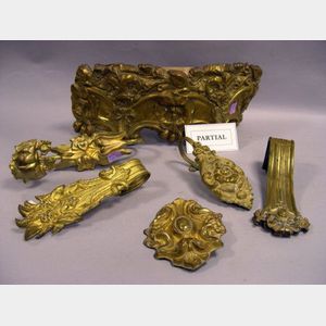 Collection of Approximately Twenty-five Gilt Molded Brass Curtain Tiebacks and a Valance Crest