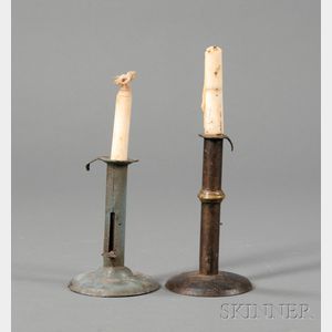 Two Iron Hogscraper-form Candlesticks