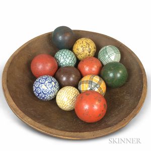Red-painted and Turned Pine Bowl and Twelve Wood and Ceramic Carpet Balls