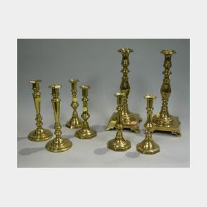 Four Pairs of Brass Candlesticks and a Pair of Cast Iron Figural Andirons.