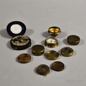 Seven Small Brass Compasses