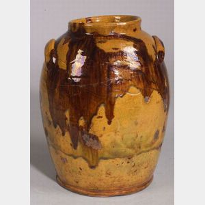 Slip Decorated Redware Jar, America, early 19th century, raised rim on large ovoid form with applied lug handles, two incised wavy line