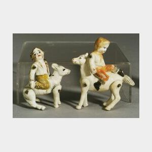 Two Bisque Boys Molded Riding Horses