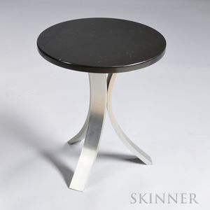 Side Table in the Manner of Harvey Probber 20th century, highly polished, round black marble top supported on three curved strap legs,