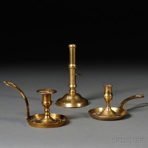Two Brass "Frying Pan" Chambersticks and a Hogscraper Candlestick