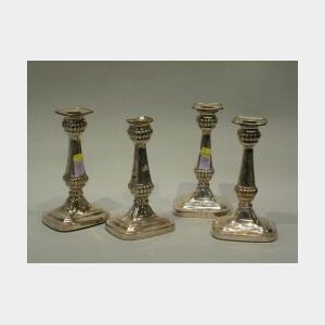 Set of Four Classical Revival Silver Plated Candlesticks. rectangular removable sconce, with reeded nozzle, tapered stem ending in reed