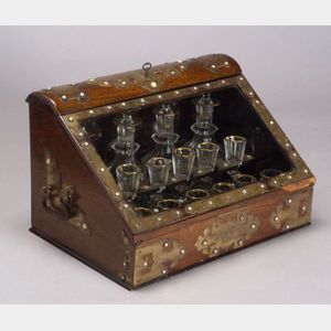Gothic Revival Rosewood and Brass Mounted Tantalus with Parcel Gilt Glassware