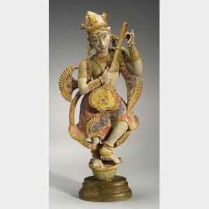Carved and Painted Indian Figure of a Divinity Tuning a Sitar