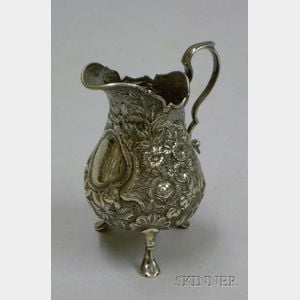 American Repousse Sterling Silver Footed Cream Jug.