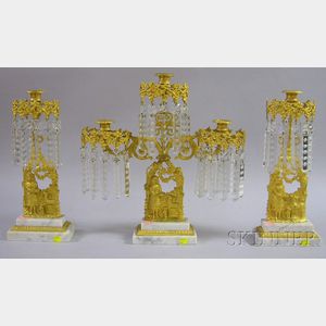 Three-piece Gilt-metal Figural and Marble Girandole Set with Prisms.
