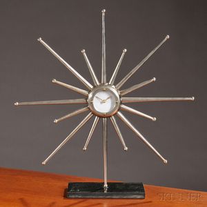 Modern Metal and Stone Starburst Clock, metal form centered by a circular dial, battery-operated clock within an orb raised on tapered