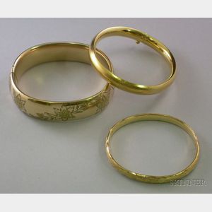 Two Gold-filled Bangles and One 14kt Gold Bangle.