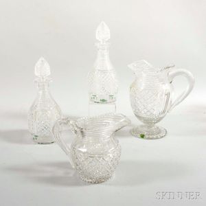Two Colorless Glass Pitchers and a Pair of Decanters