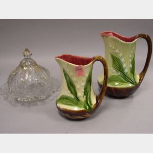 Two French Majolica Pitchers and a Victorian Art Glass Covered Cheese Dish.