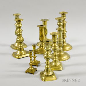 Four Pairs and Two Single Brass Candlesticks