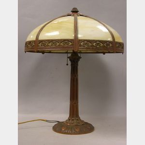Eight Bent Panel Caramel Slag Glass and Painted Cast Metal Table Lamp.