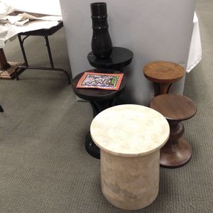 Five Carved Wood Stools and a Sequined Hat