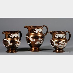 Set of Three English Earthenware Copper Lustre Pitchers