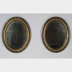Pair of Irish Georgian Giltwood, Part Ebonized, and Glass Mounted Oval Mirrors