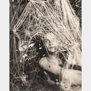 George Platt Lynes (American, 1907-1955) Three Photographs of Chuck Howard Posing Among an Adorned Tree