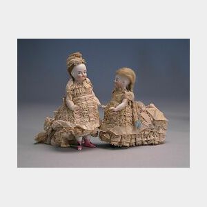 Two All Bisque Dolls with Trains