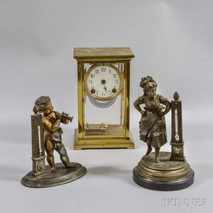 Two Victorian Base Metal Figural Thermometers and a Crystal Regulator