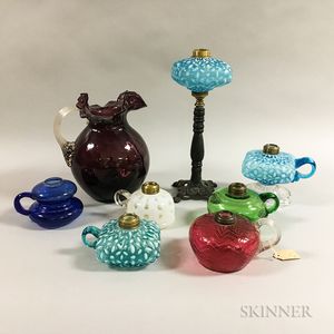 Seven Colorless Glass Oil Lamps and an Amethyst Pitcher