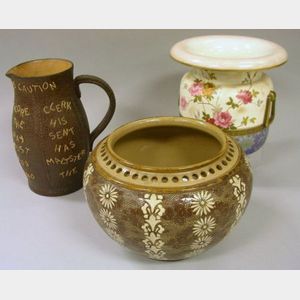 Doulton Motto Leather Stoneware Pitcher, Decorated Pierced Stoneware Jardiniere, and a Burslem Gilt and Floral Decorated Spittoon.