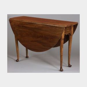 Queen Anne Walnut Drop Leaf Table, with d-shaped drop leaves and scalloped apron, on circular legs on pad feet, ht. 27 1/2, lg, 42, wd.