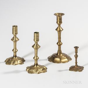 Three Brass Petal-base Candlesticks and a Taperstick