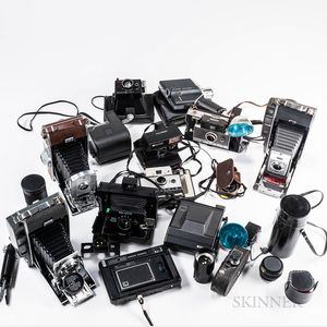 Collection of Polaroid Cameras, Accessories, and a Tripod