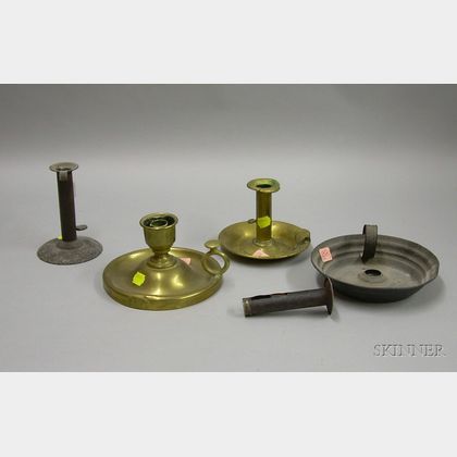 Two Brass Chambersticks, an Iron Hogscraper Candlestick, and a Tin Chamberstick. 