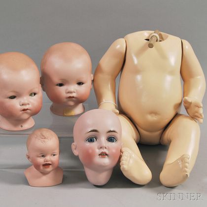 Four Bisque Doll Heads and a Composition Baby Body