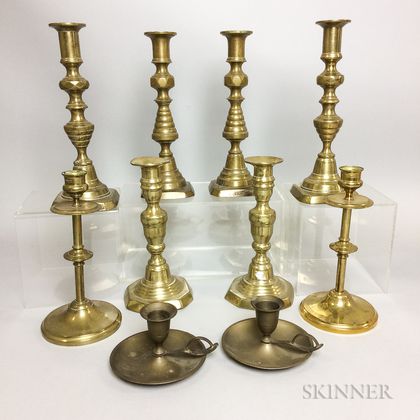 Four Pairs of Brass Candlesticks and a Pair of Brass Chambersticks