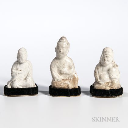 Three Miniature Cream-glazed Earthenware Figures