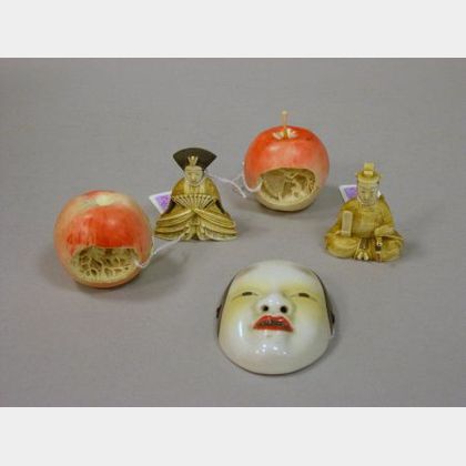 Japanese Carved Ivory Emperor and Empress Figures, a Small Porcelain Mask, and a Pair of Chinese Carved Ivory Apples with Interior Land