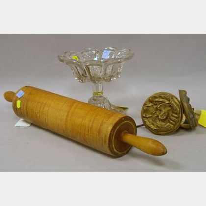 Pressed Loop Pattern Flint Glass Compote, a Tiger Maple Rolling Pin, and a Pair of Molded Brass Eagle Medallion Curtain Tiebacks. 