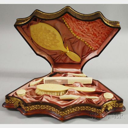 Continental-style Gilt-metal Mounted Leather-clad Wooden Fan-shaped Dresser Box with an Eight-piece Ivorine Dresser Set. 