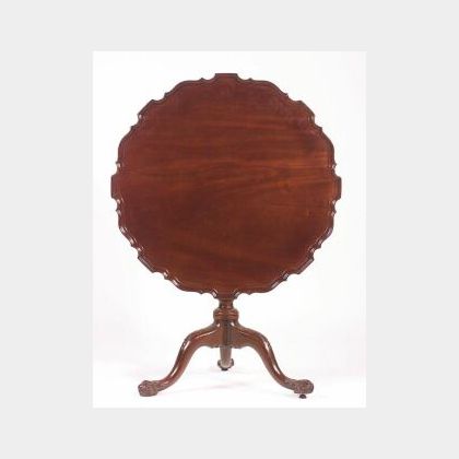 George III Mahogany Tilt-top Tripod Table, 18th century, with pie crust top above a spiral fluted stem on carved cabriole legs ending i