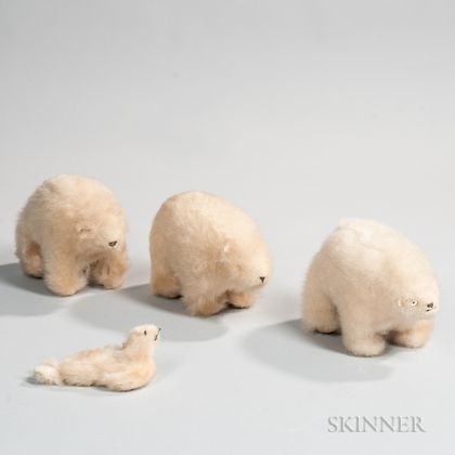 Three Stuffed Polar Bears and a Stuffed Seal