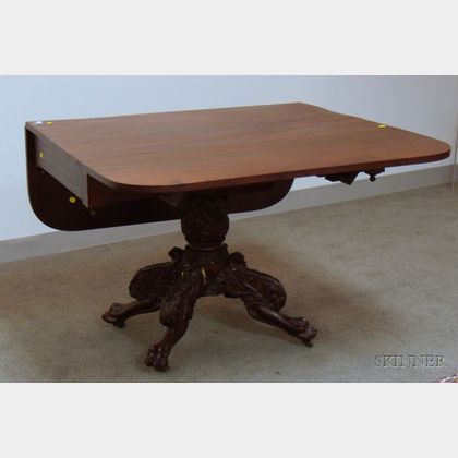 Classical Carved Mahogany and Mahogany Veneer Drop-leaf Pedestal-base Table with Paw Feet